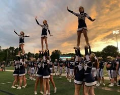 a group of cheerleaders standing on top of each other