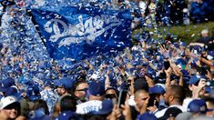 a large group of baseball players are celebrating with confetti