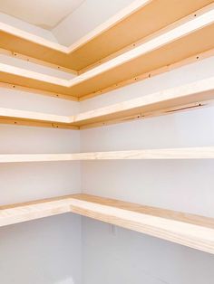 empty shelves in a white room with no people