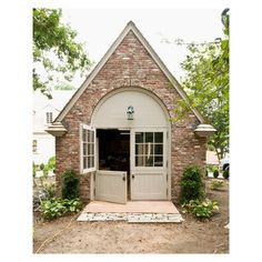 a small brick building with an open door