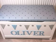 a blue and white toy chest with stars on the top that says,'silver '