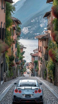 a car parked on the side of a cobblestone road