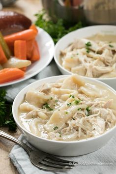 two bowls filled with chicken and dumplings next to carrots