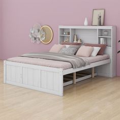 a bedroom with pink walls and white furniture