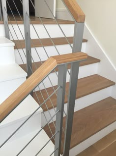 a close up of some stairs with wood and metal handrails