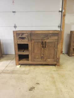 a large wooden cabinet sitting inside of a room next to a white wall and floor