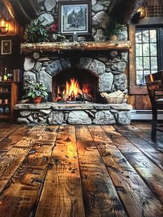 a living room filled with furniture and a fire place in the middle of a wooden floor