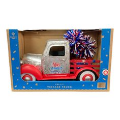 an old fashioned toy truck with fireworks in it's back end and the box opened