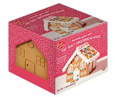 a pink box with a gingerbread house inside