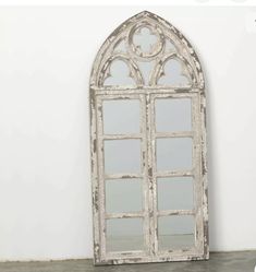 an old white window frame with mirrors on it