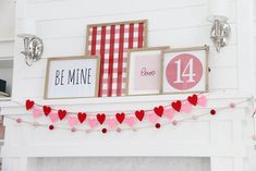 valentine's day mantel decorated with red and pink hearts