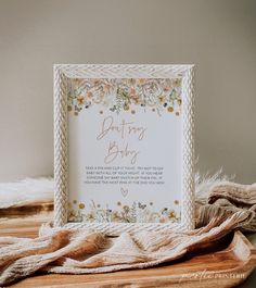 a greeting card on a wooden table next to a blanket