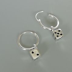 A PAIR of sterling silver hoops. Comes with a detachable dice charm. The charm is multipurpose and can be used with a neck or bracelet chain too. Dimension: Hoop- 12x1 mm Charm: 5 x8 mm Drop length- 19 mm These earrings are made of real 925 hypoallergenic sterling silver. Please let me know if you want the piece in a gift box. I can write out a message from you to the receiver if needed. Please be free to contact me at... bhavnakwintra1956@gmail.com More hoops: https://www.etsy.com/your/shops/Th Nickel-free Metal Dangle Huggie Earrings, Silver Huggie Jewelry With Charms, Sterling Silver Huggie Earrings With Dangling Charms As Gift, Silver Sterling Huggie Earrings With Dangling Charms, Silver Huggie Earrings With Charms, Charm Small Hoop Metal Earrings, Silver Charm Earrings For Everyday, Nickel-free Silver Dangle Huggie Earrings, Silver Nickel-free Dangle Huggie Earrings