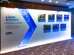 an exhibit wall with pictures on it in a conference room at the dpaa