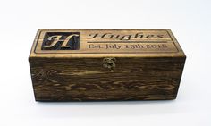 a personalized wooden box with the initials and date engraved on it's lid