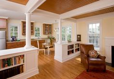 a living room filled with furniture and a fire place next to a refrigerator freezer