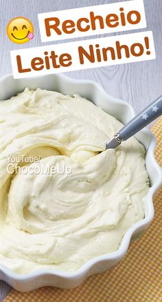 a bowl filled with whipped cream sitting on top of a yellow and white checkered table cloth