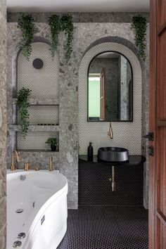 the bathroom is decorated in black and white tile with greenery growing on the walls