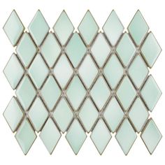 the back side of a glass mosaic tile with diamond shapes in light green and white