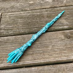 a blue tasseled umbrella sitting on top of a wooden bench