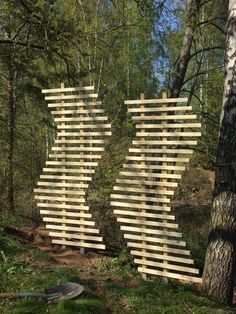 two wooden sculptures in the middle of a forest