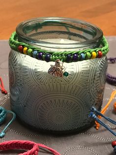 a glass jar sitting on top of a table covered in beads