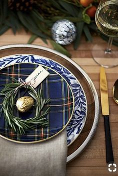 the place setting is set with gold and blue plates, silverware, and napkins