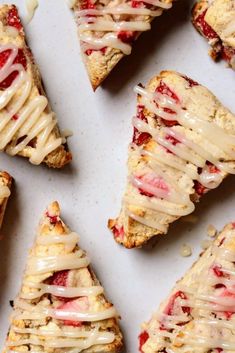 several slices of strawberry scones with icing on them