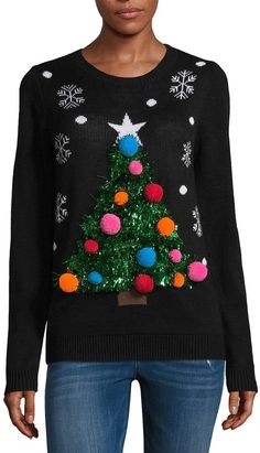 a woman wearing a black sweater with a christmas tree on it