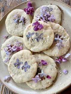 purple flowers are sprinkled on the top of these short - lived, round cookies