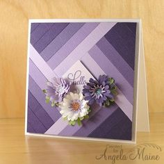 a close up of a greeting card with flowers on the front and purple stripes in the back