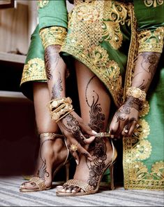 the legs and feet of a woman with henna tattoos