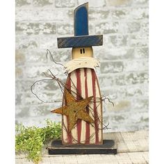 a wooden toy with a hat and star on it