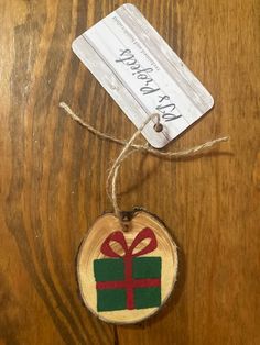 a wooden ornament with a gift box on it