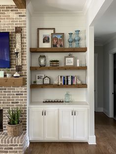 a living room filled with furniture and a fire place under a flat screen tv mounted on a wall