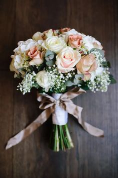 a bouquet of flowers tied to a wooden table