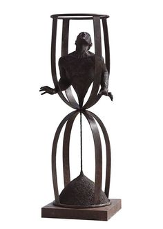 a sculpture of a man sitting on top of a chair