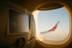 an airplane window looking out at the sky