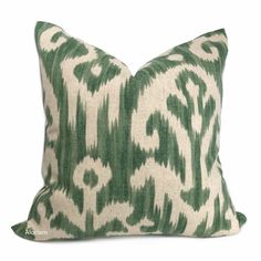 a green and white pillow on a white background