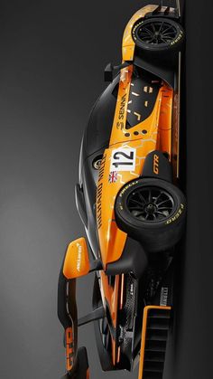 an orange race car is shown from above on a black background with space for text