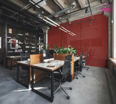 an empty office with desks and chairs