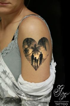 a woman's arm with a heart shaped tattoo on it, and two people walking down the beach