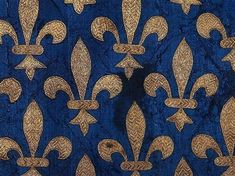 a blue and gold fabric with fleur de lis on it