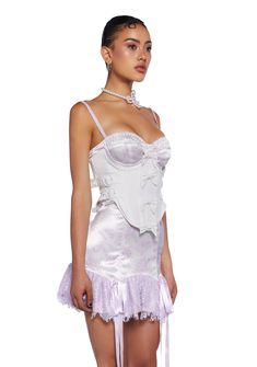 cuz make a statement on the dance floor. This underbust corset top has a linen construction with a satin lining, structured boning, an underwire bust, a satin ribbon lace-up design on the back, adjustable buckle closures on the sides, decorative bows on the front, a curved hem, and a side zipper closure. Underbust Corset Belt With Built-in Bra For Party, Feminine Underbust Corset With Built-in Bra, Feminine Wedding Corset With Built-in Bra, Strapless Feminine Corset With Lace Trim, Feminine Strapless Corset With Lace Trim, Feminine Lace Corset With Corset Back, White Underbust Corset With Built-in Bra, Fitted Lace Corset Dress In Coquette Style, Fitted Corset With Boned Bodice And Spaghetti Straps