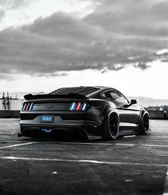 a black sports car parked in a parking lot