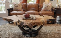 a living room filled with furniture and a fire place in the middle of carpeted flooring