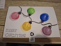 a handmade christmas card with watercolor lights