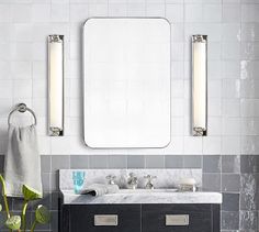 a bathroom with two sinks and a large mirror above the sink in front of it