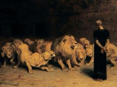 a woman standing in front of a group of lions with one lion looking at the other