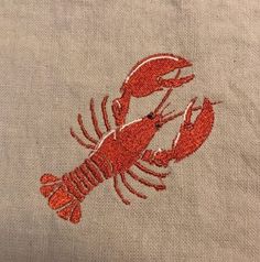 two red lobsters embroidered on the side of a linen bag